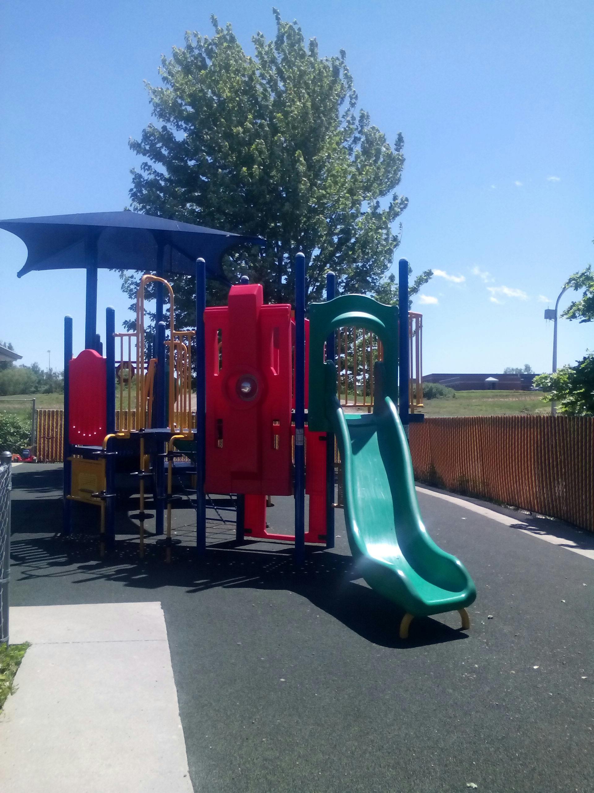 Playground structure with slides and climbing elements