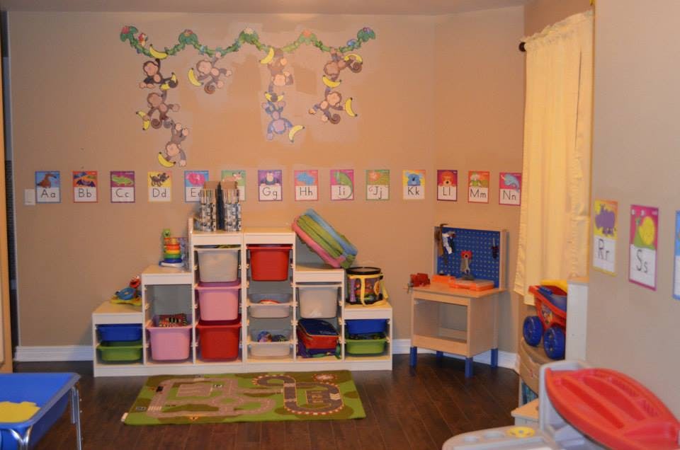 Playroom with toy storage, rug, and wall decorations