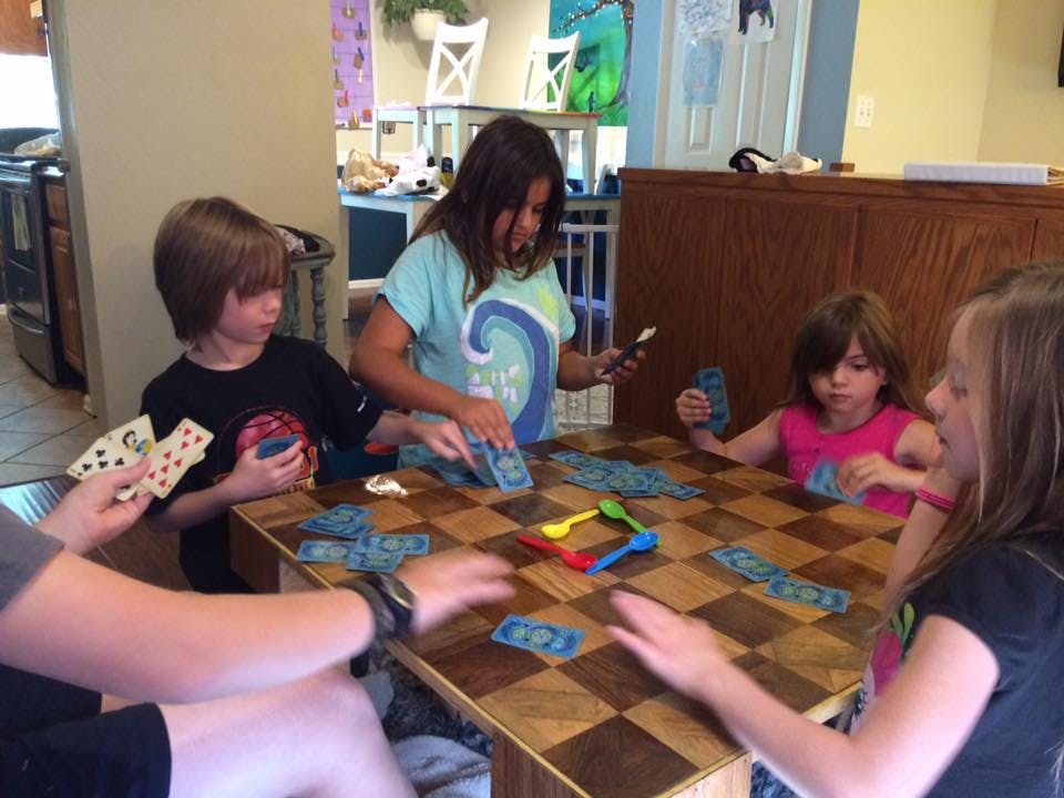 Children playing a card game at a table
