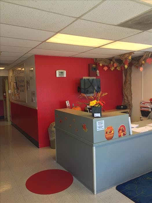 Reception desk with fall decorations in an indoor waiting area