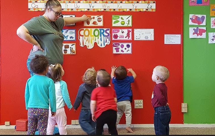Person teaching children in a classroom