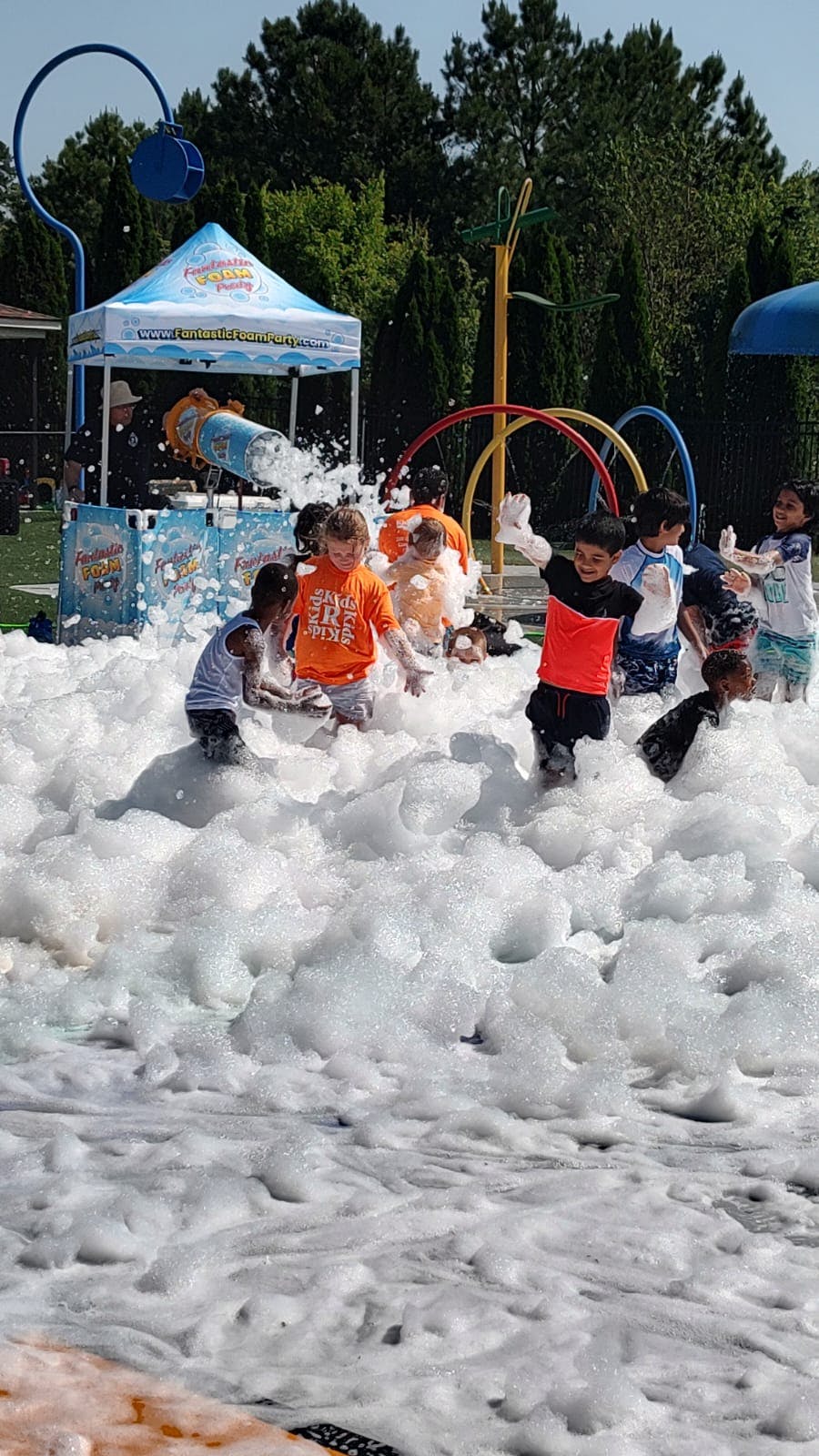 Children playing in a large pile of foam outdoors