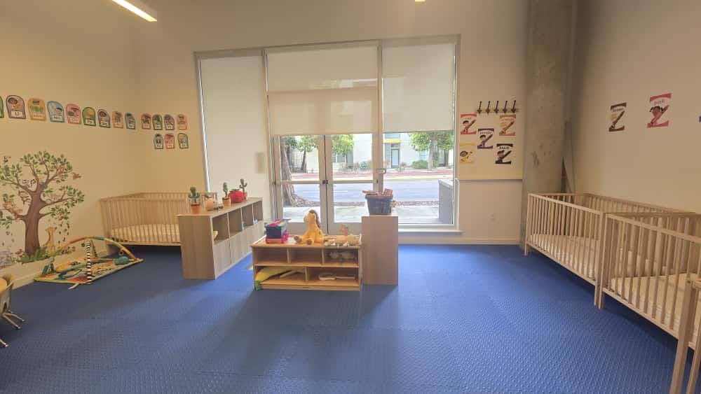 Nursery room with cribs and play mats