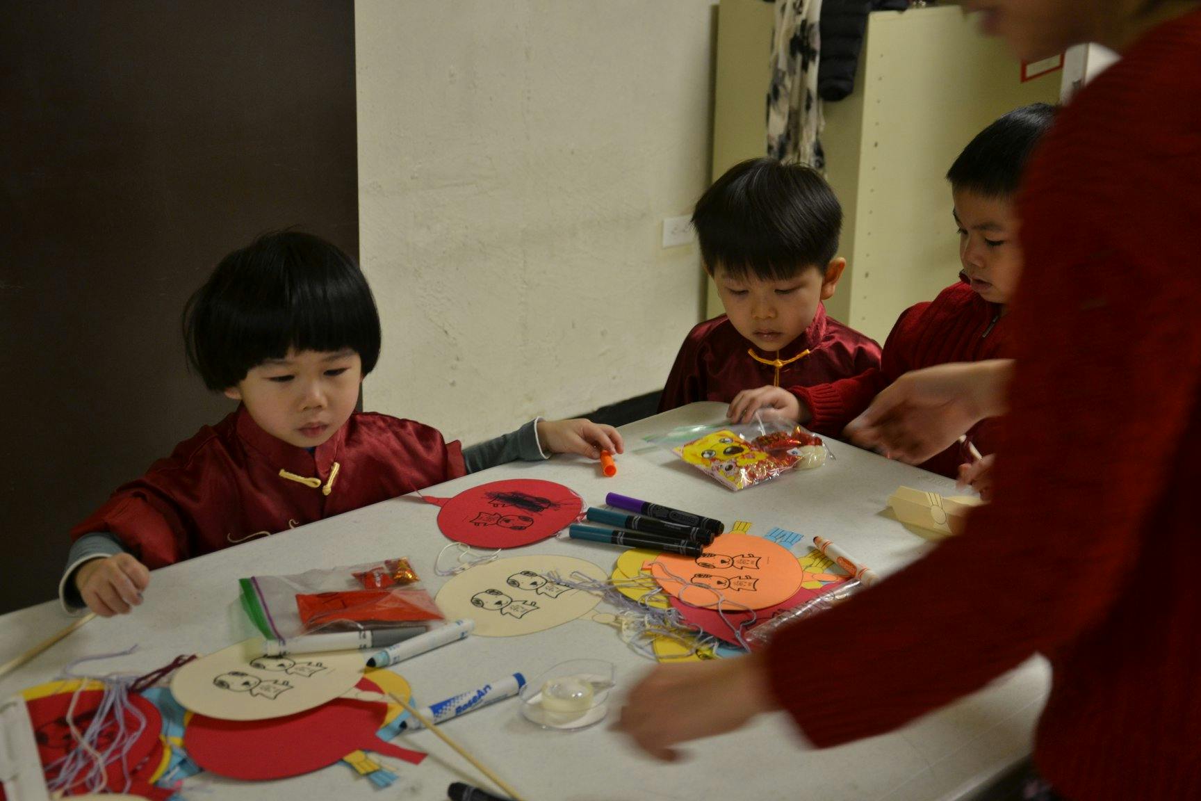 Children at a table with craft supplies