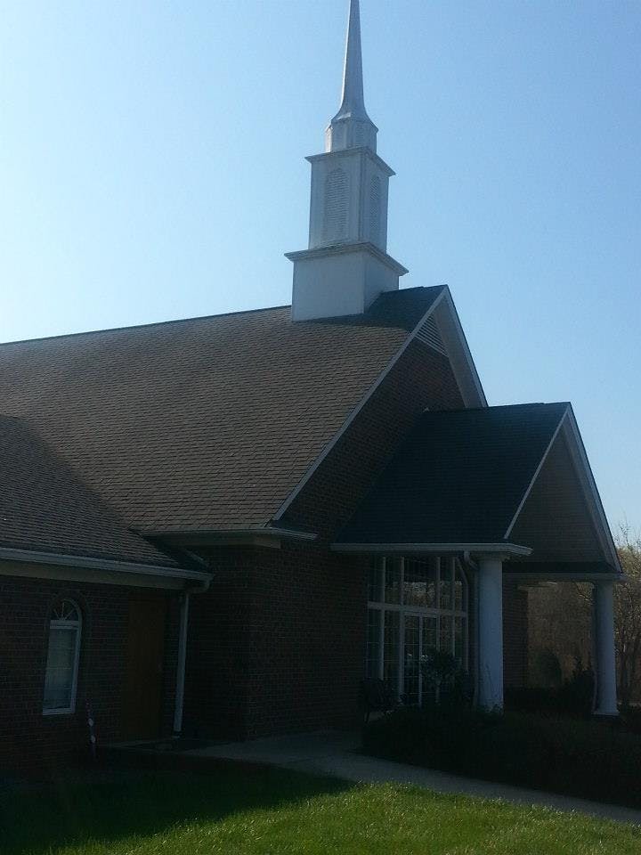Building with a steeple and a covered entrance