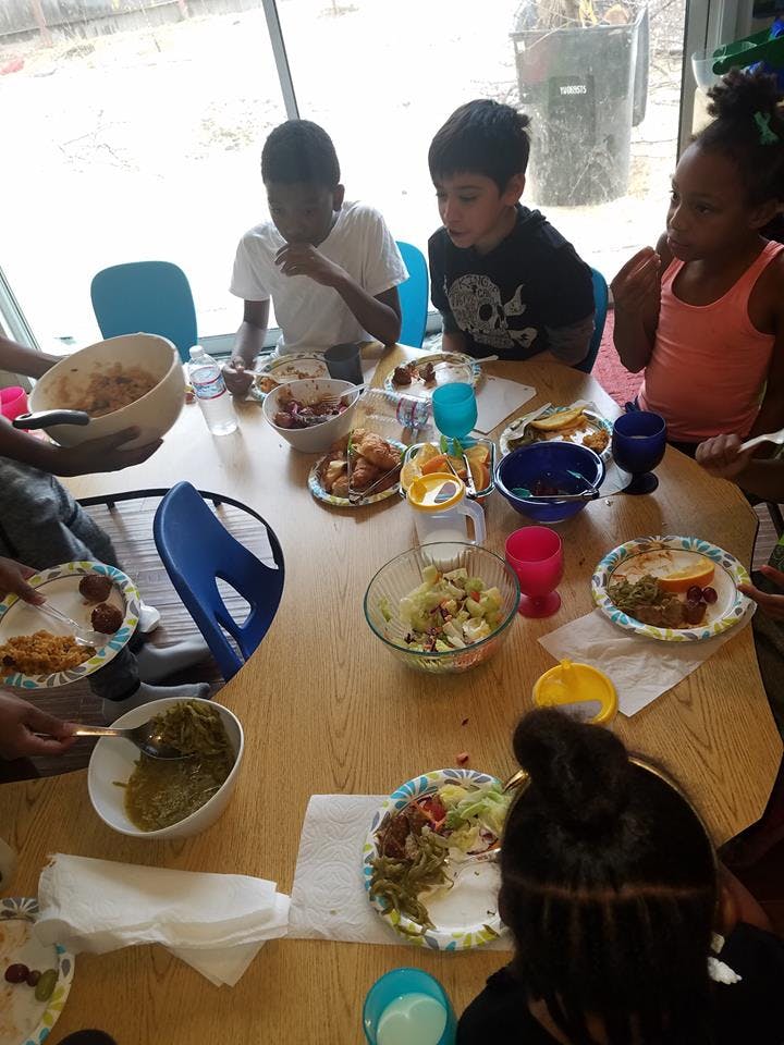 Children and adults eating a meal together at a table