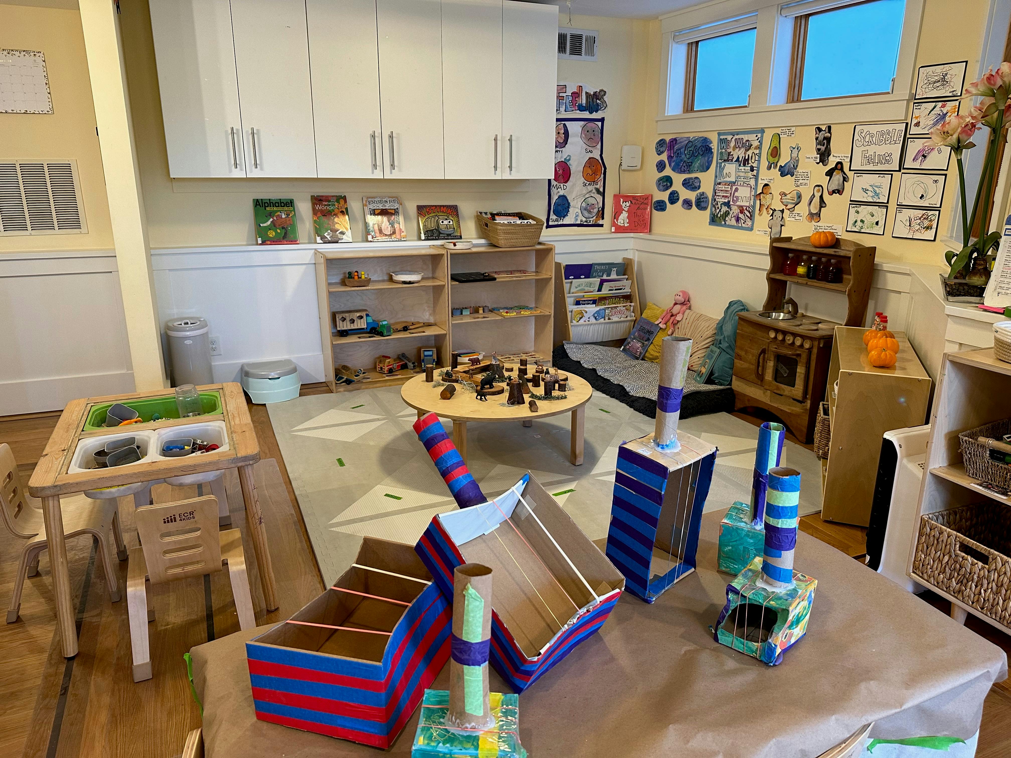 Playroom with various toys, tables, and shelves