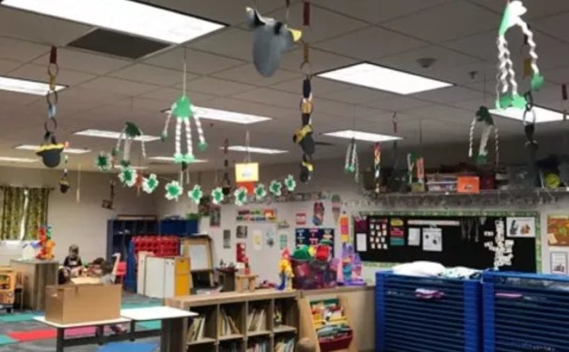 Classroom with decorations hanging from the ceiling and various learning materials