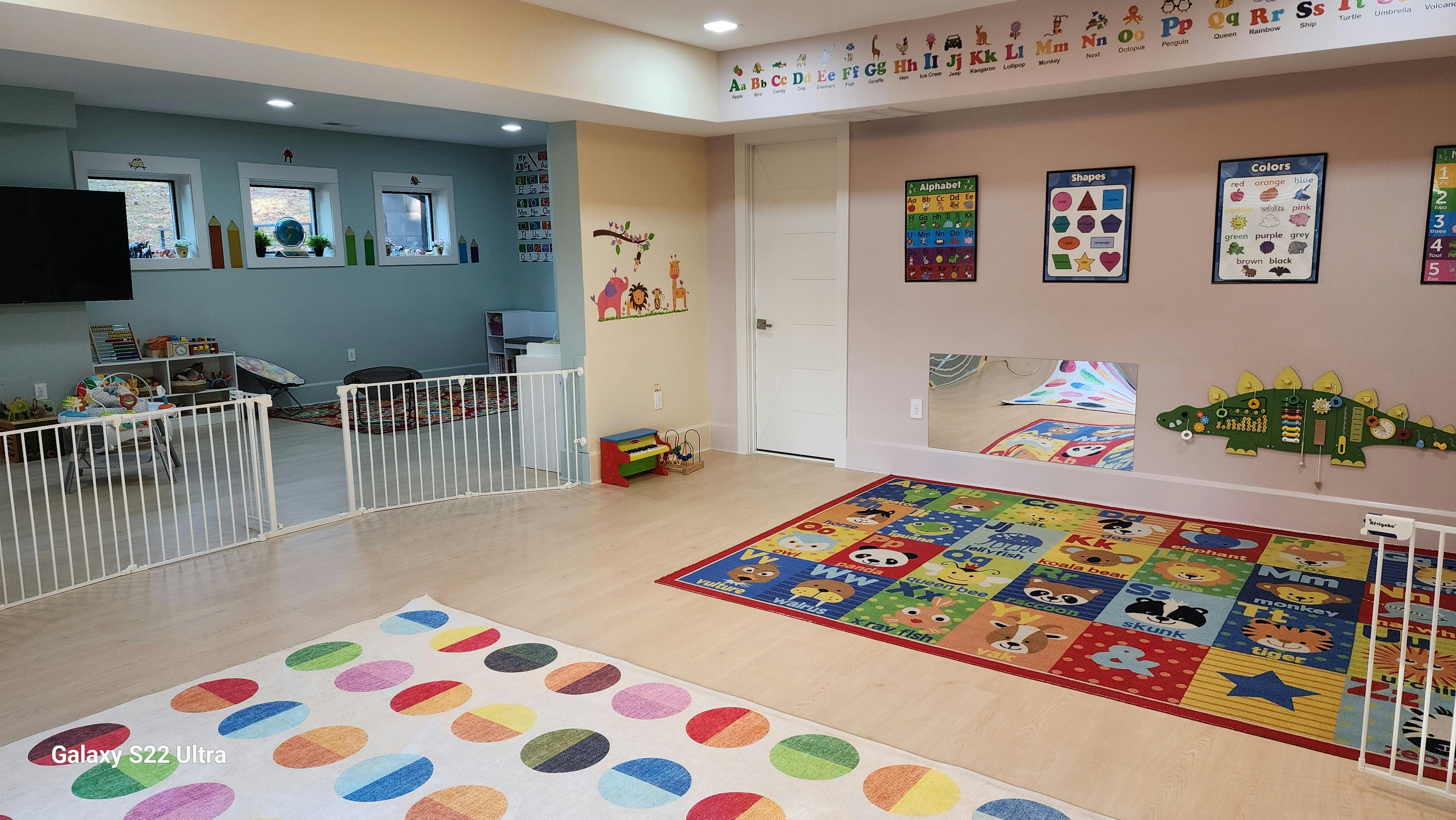 Playroom with colorful rugs and child safety gates