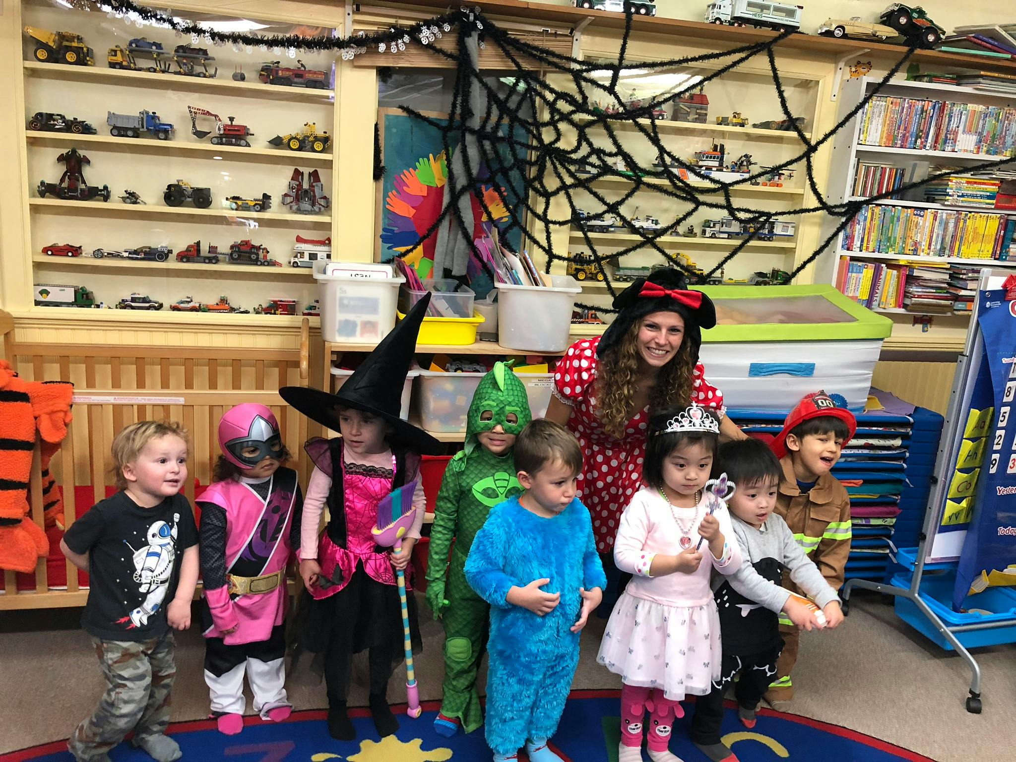 Adult and children in costumes in a classroom
