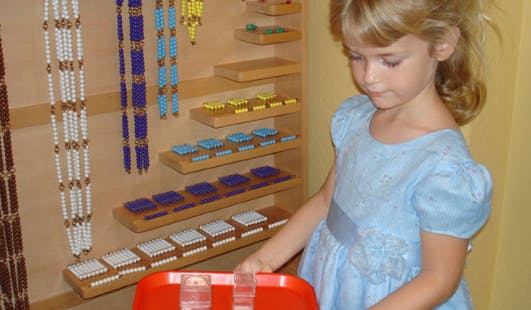 Child carrying a tray with two glasses