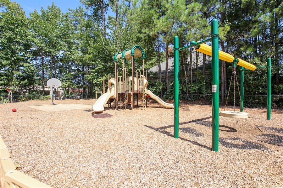 Playground with slides, swings, and a basketball hoop
