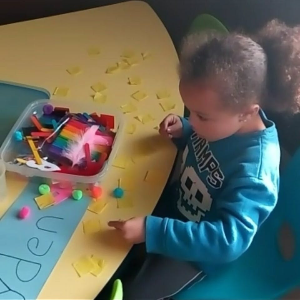 Child at a table with craft supplies