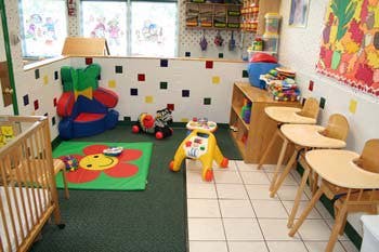 Child's play area with toys, crib, and high chairs