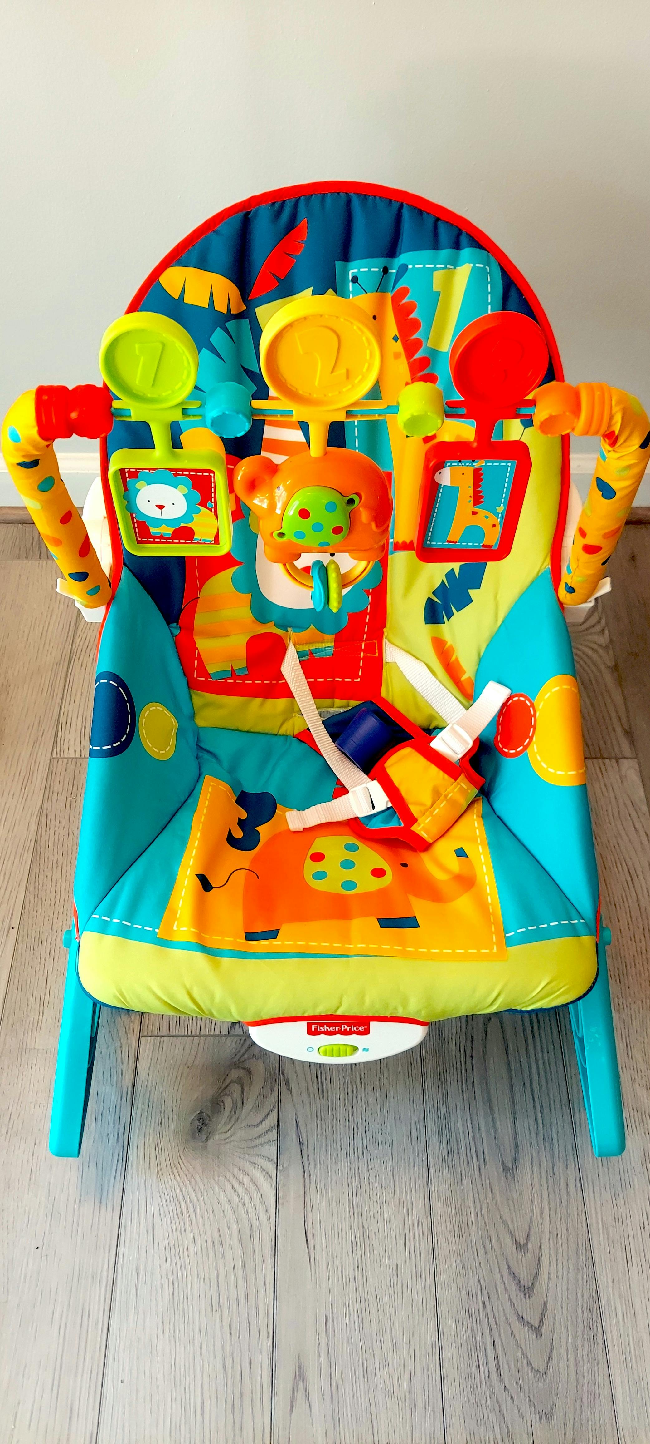 Colorful baby bouncer with toys and harness