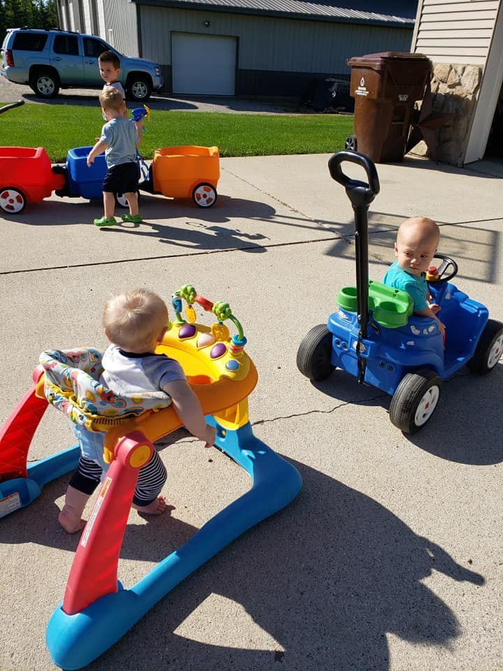 Three children playing with toys outdoors