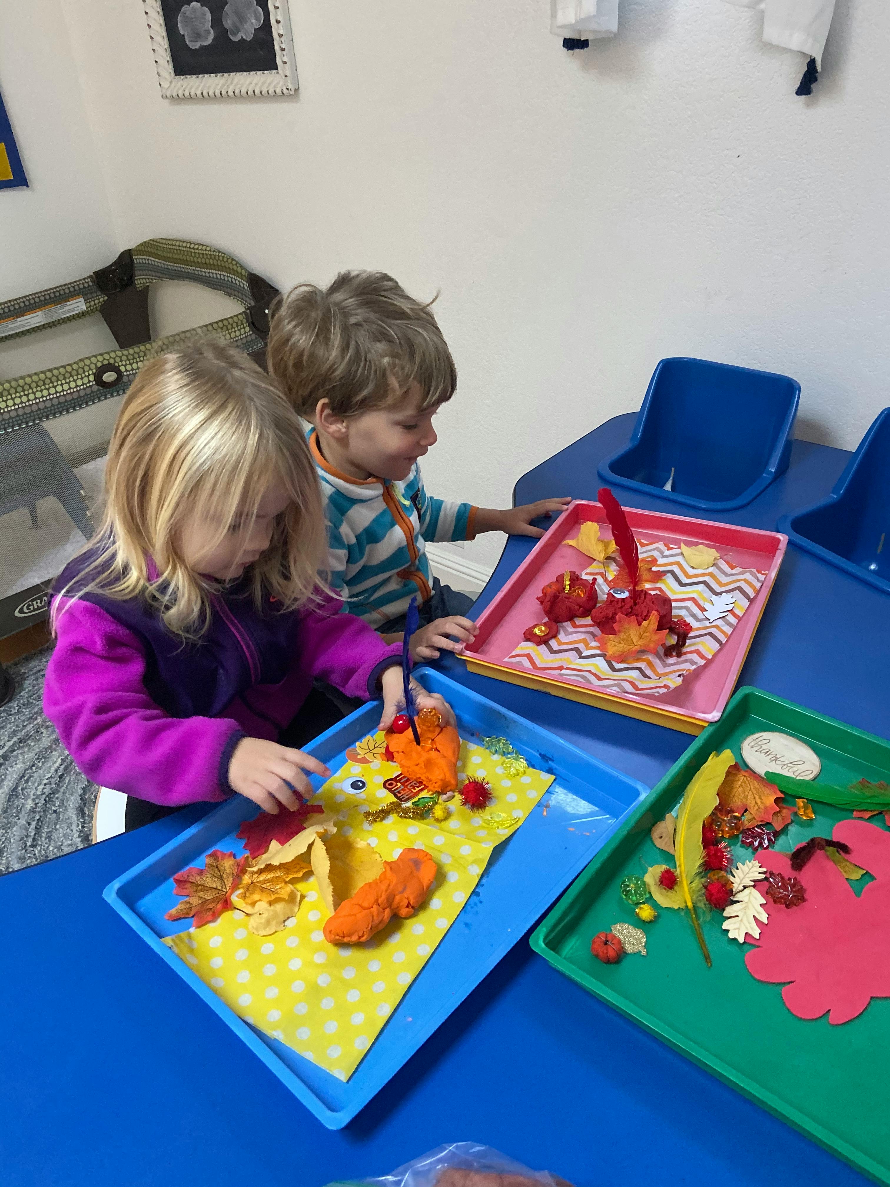 Two children doing crafts at a table