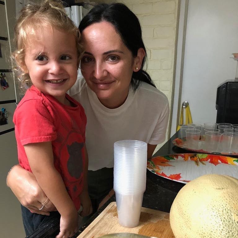 Person and child smiling in a kitchen
