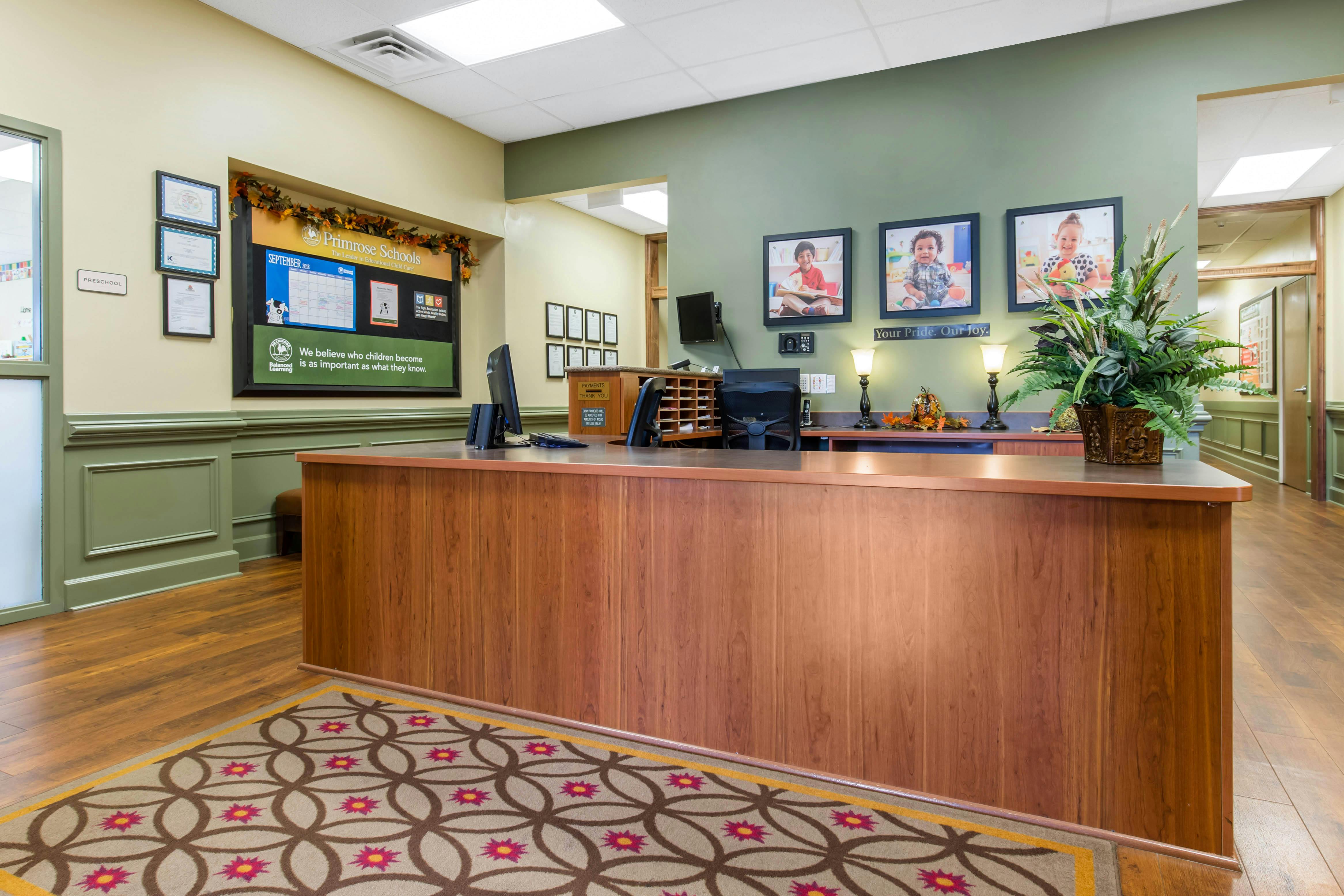 reception area of a school with a front desk and bulletin board