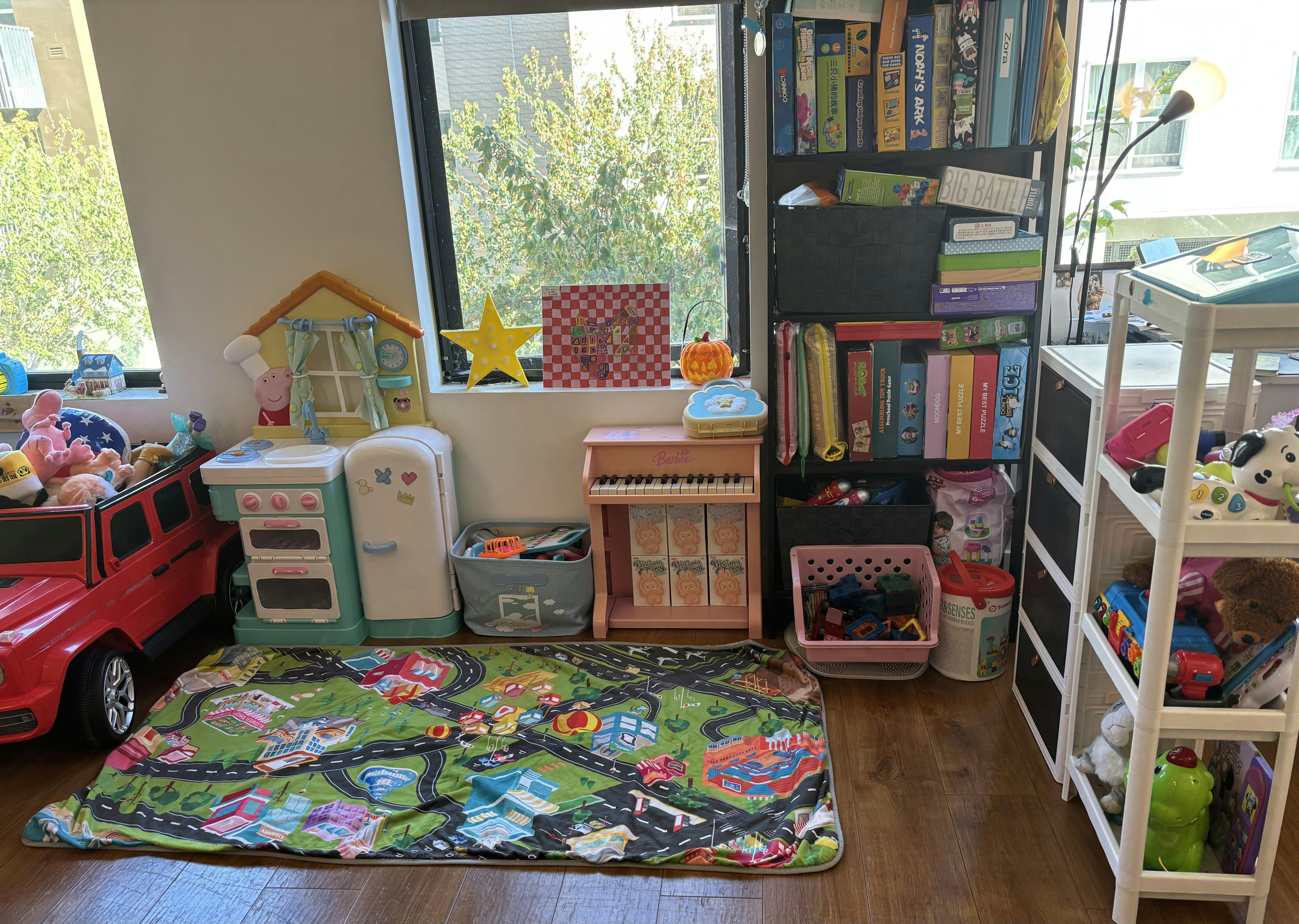 Playroom with toy kitchen, piano, car, and road mat