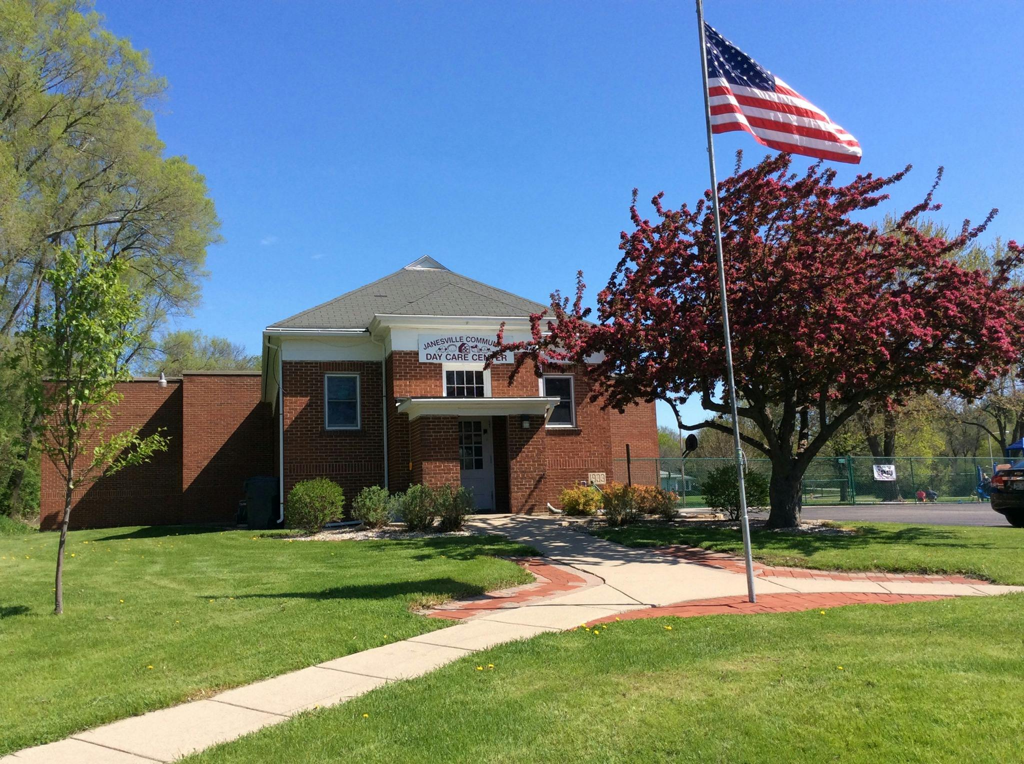 Brick building with a flag pole and American flag in front