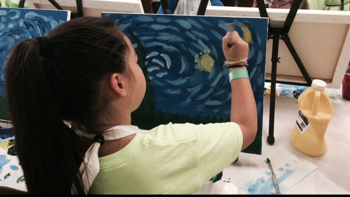 Child painting on a canvas