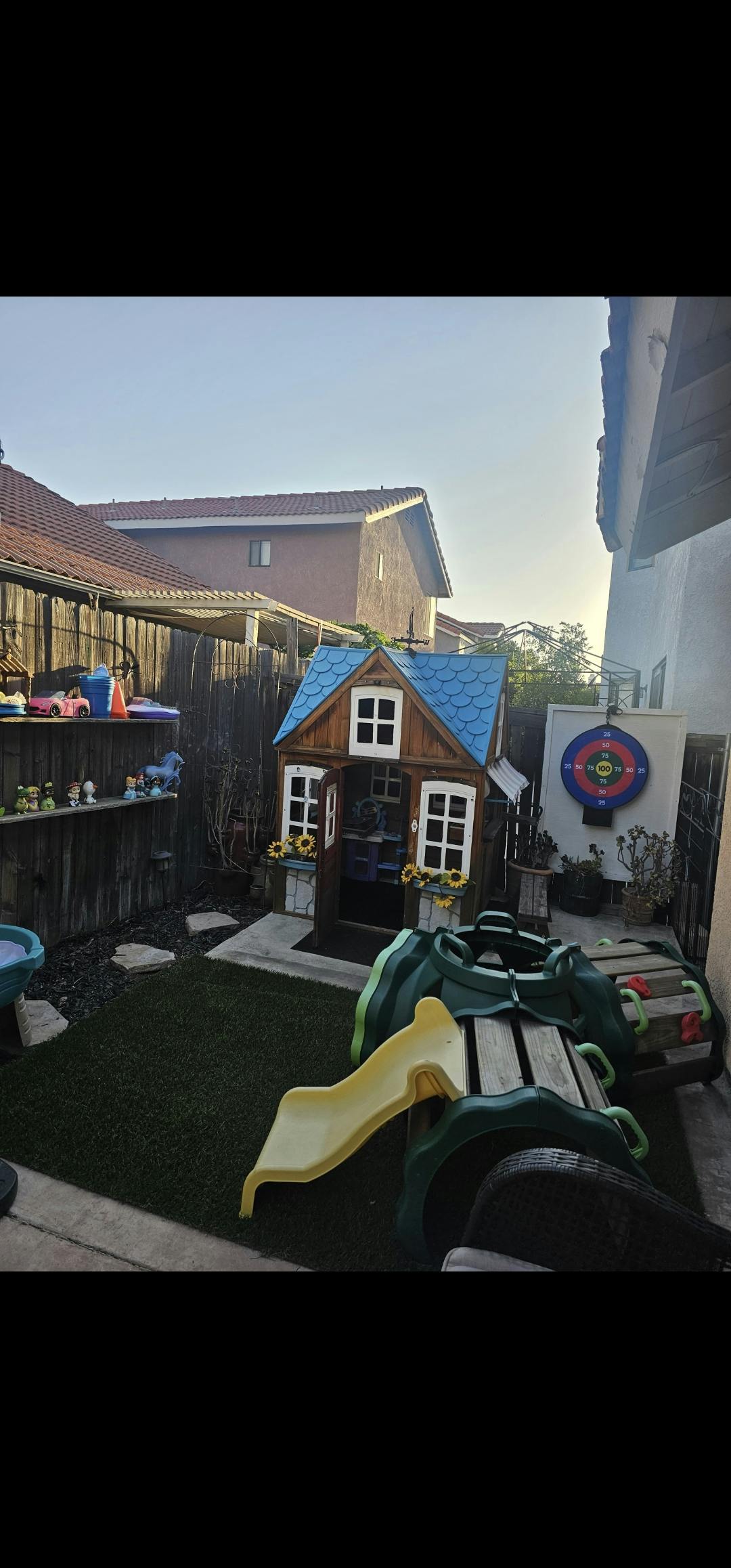 Playhouse and slide in a backyard