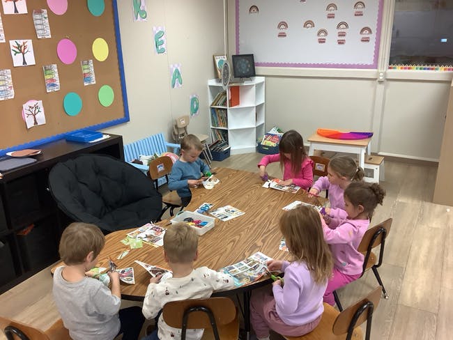 Children sitting around a table in a classroom