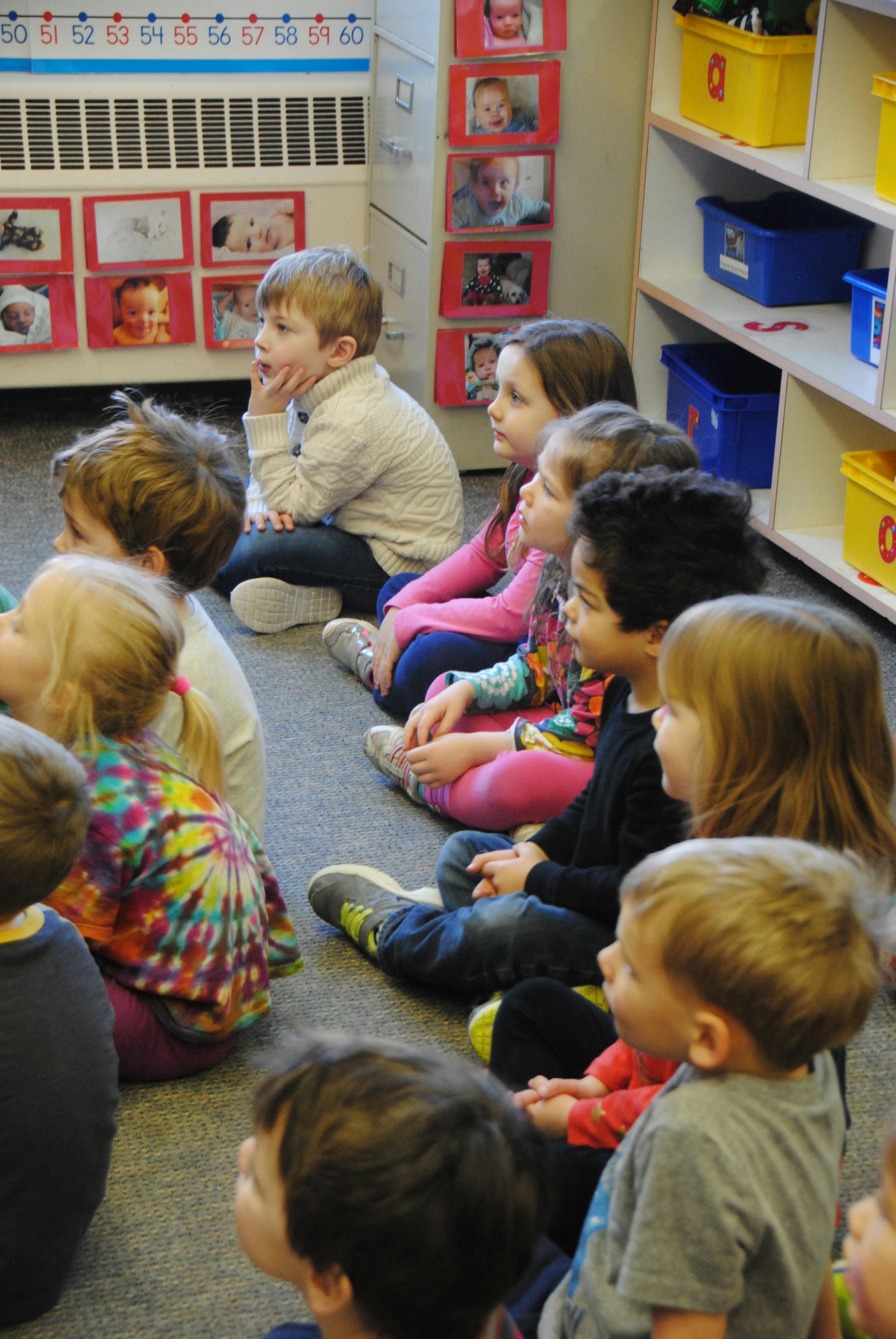 Children sitting on the floor in a classroom