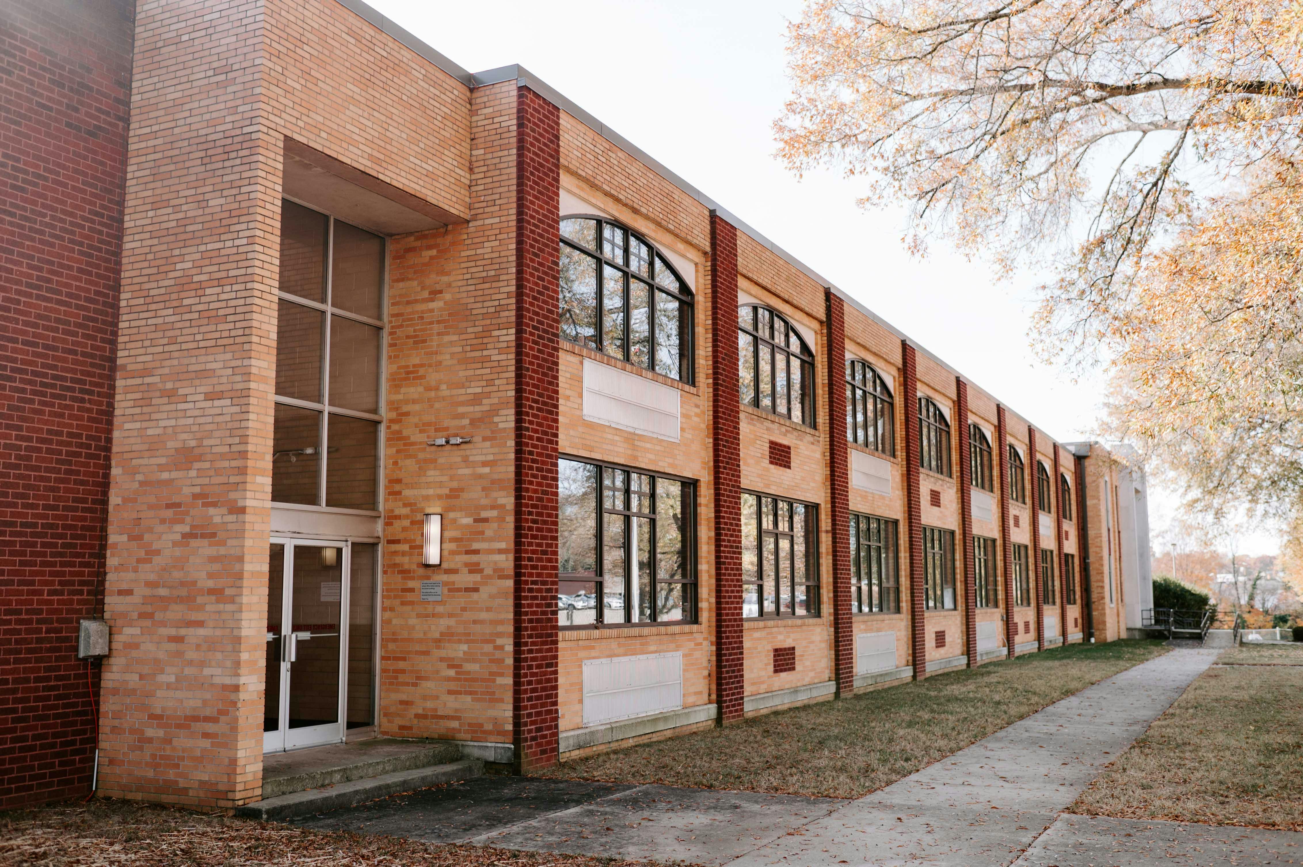 Brick building with large windows and a glass entrance