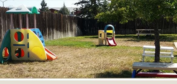 Playground with two slides and picnic tables