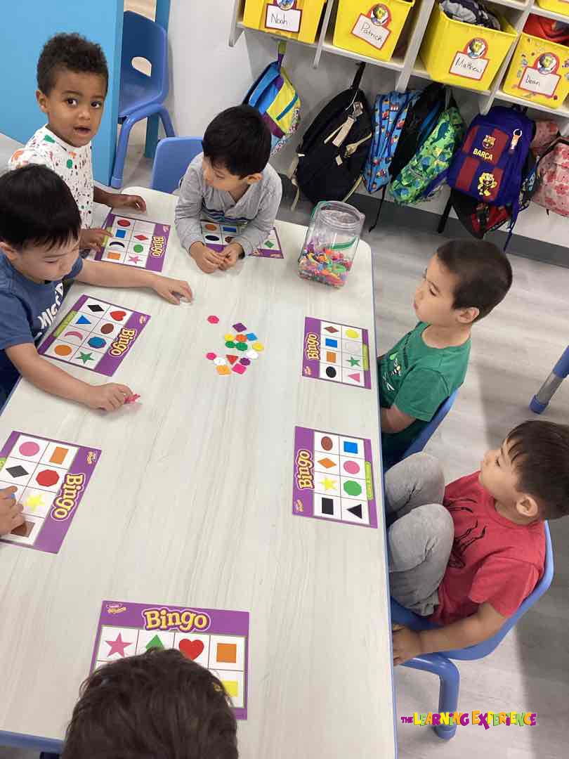 Children playing Bingo at a table