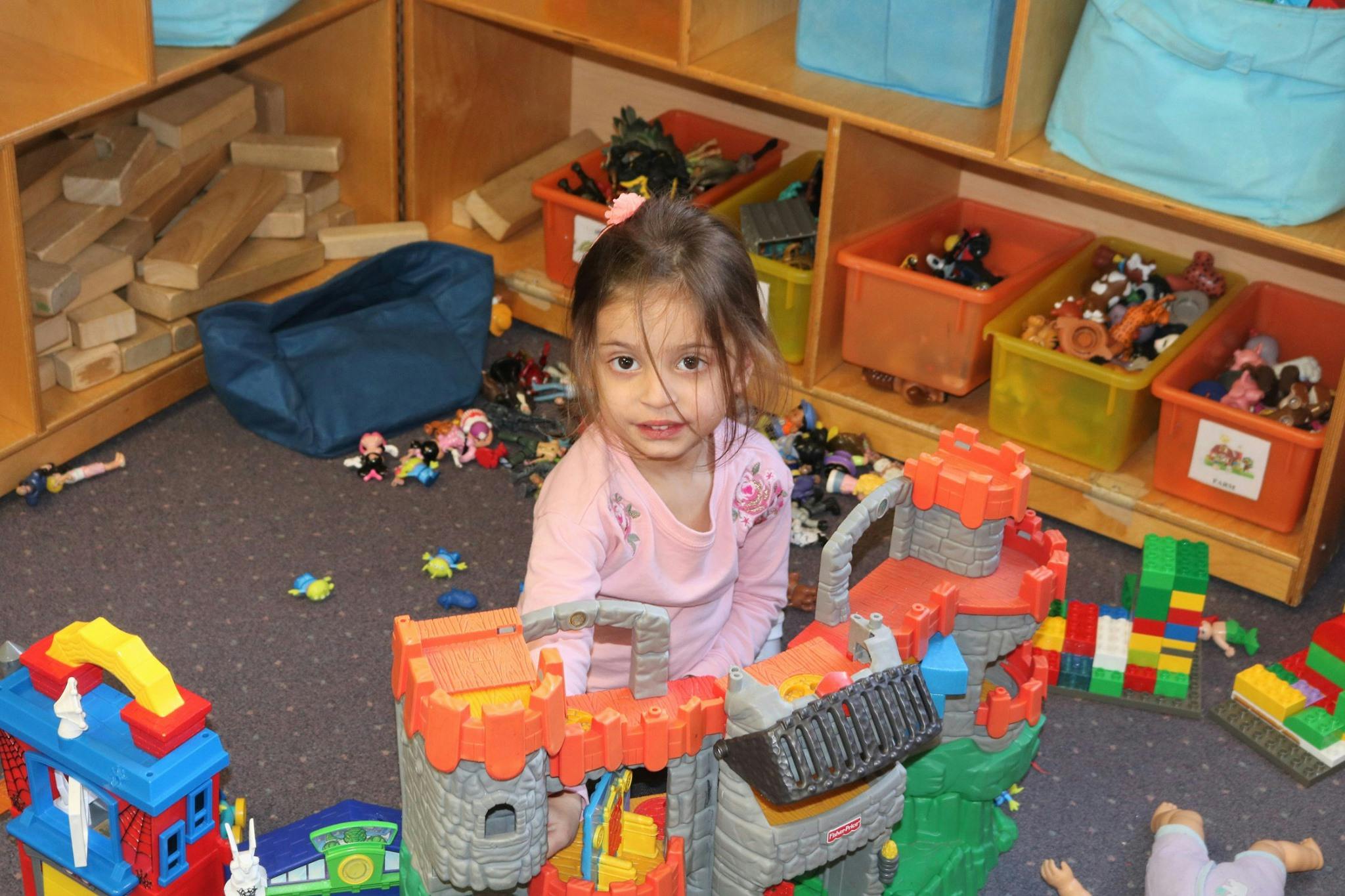 Child playing with toys on the floor
