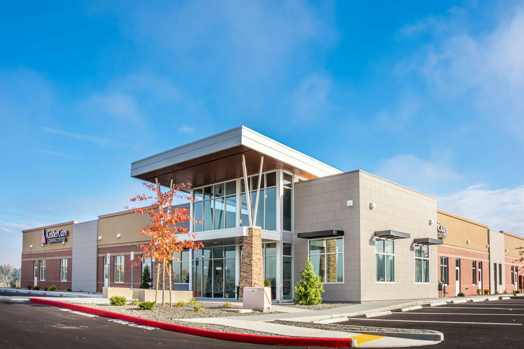 Building with "KinderCare Learning Centers" sign and a parking lot