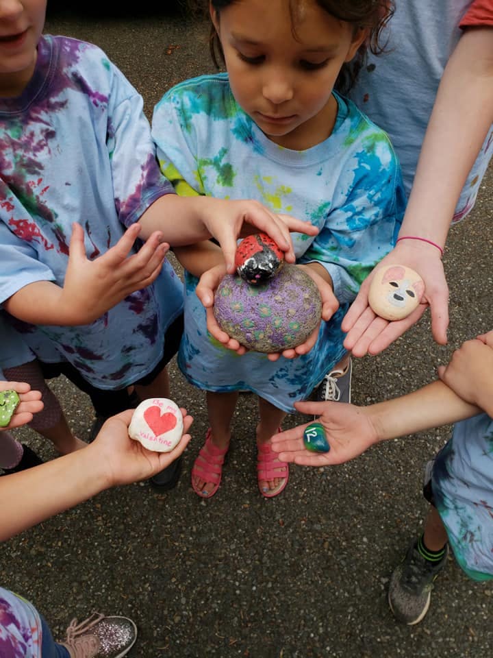 Children holding painted rocks