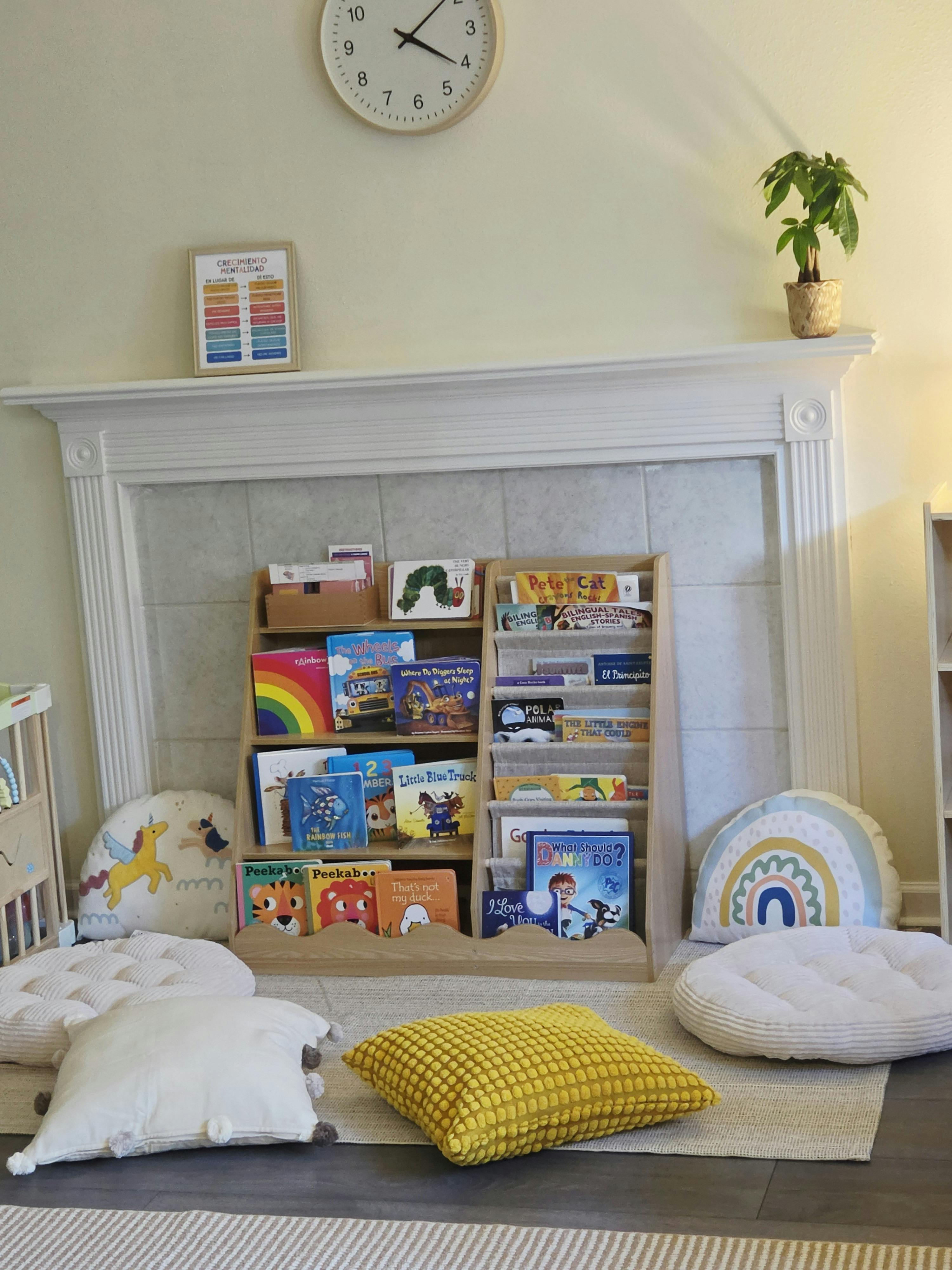 Children book display shelf on a fireplace hearth with floor pillows