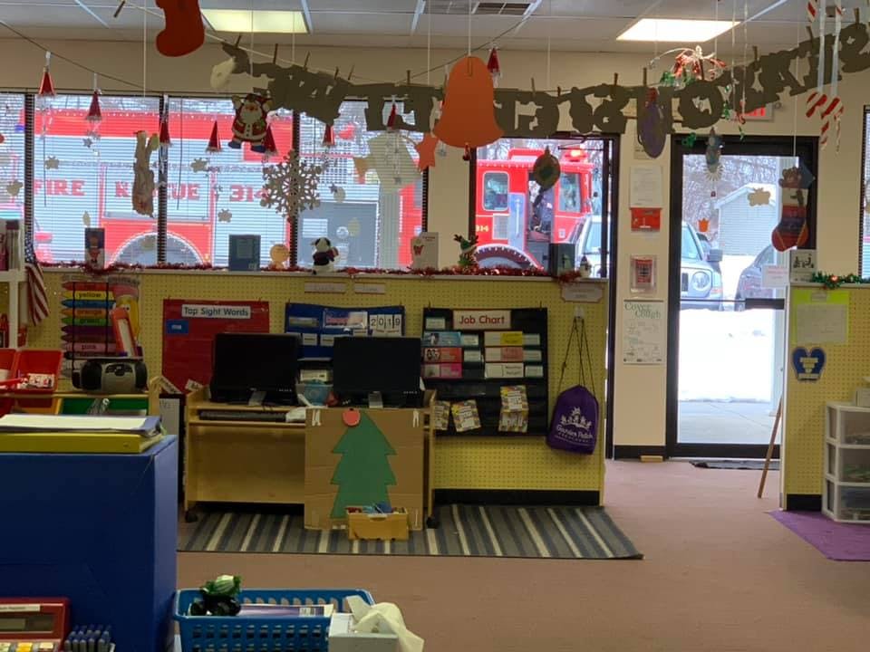 Classroom with computers and decorations, fire truck visible through window
