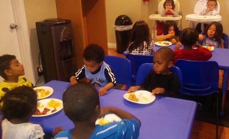 Children eating at tables in a room