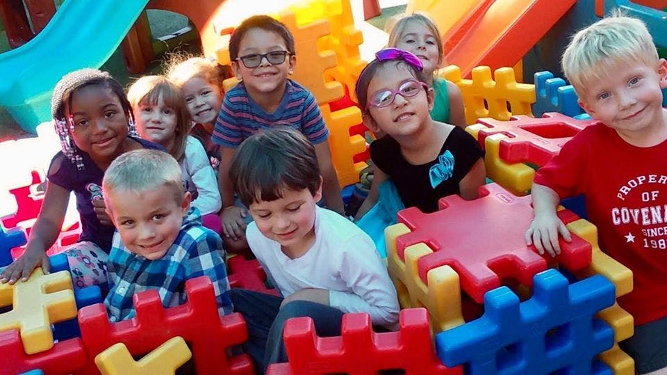 Group of children playing with large colorful building blocks