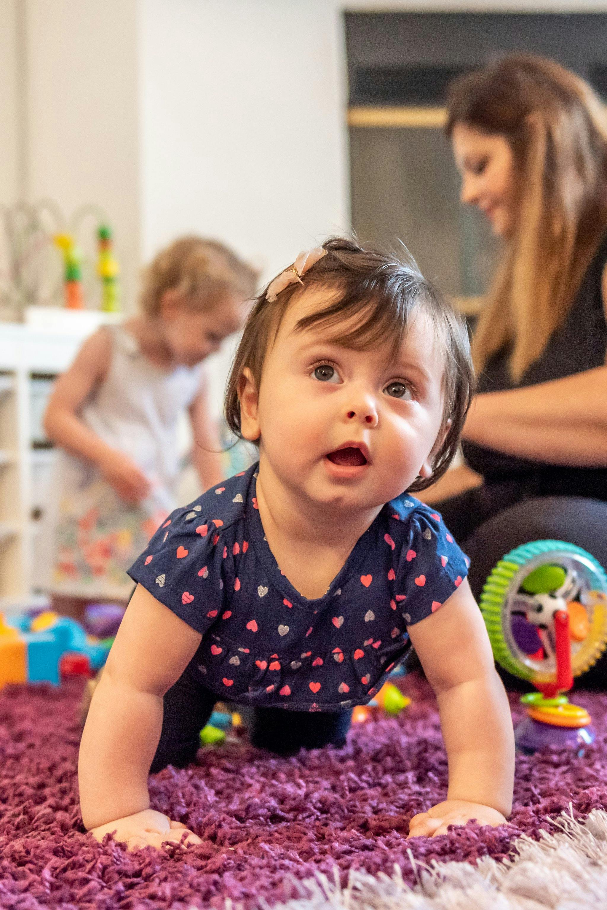 Child crawling on a purple rug