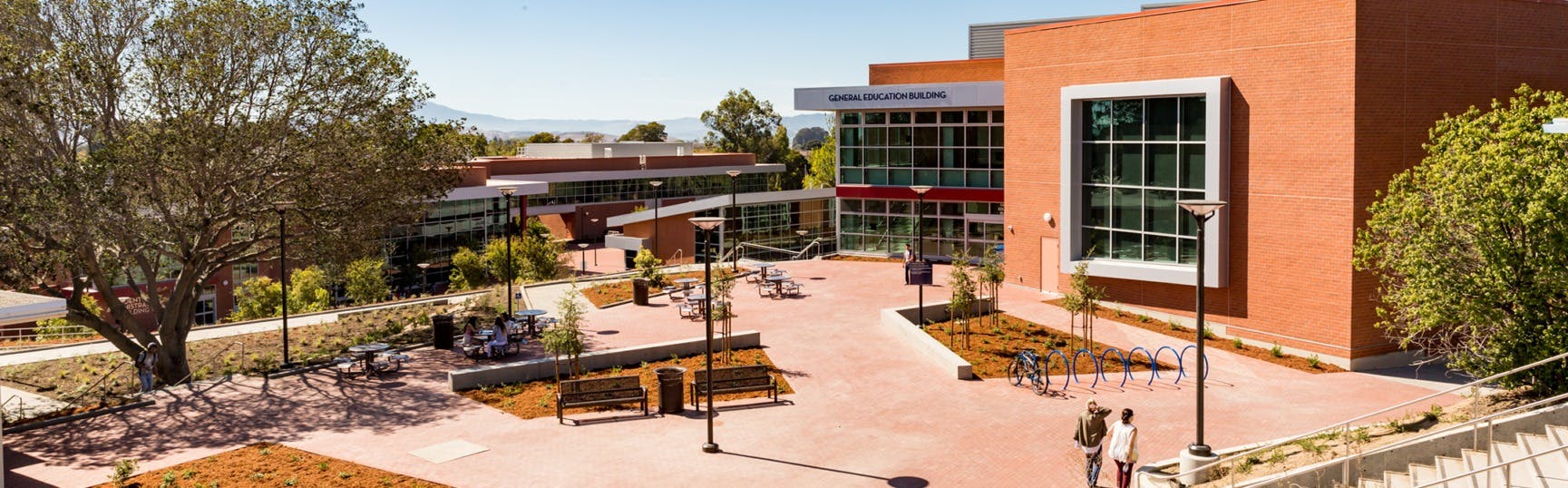 Outdoor view of a campus with buildings, trees, and a paved area