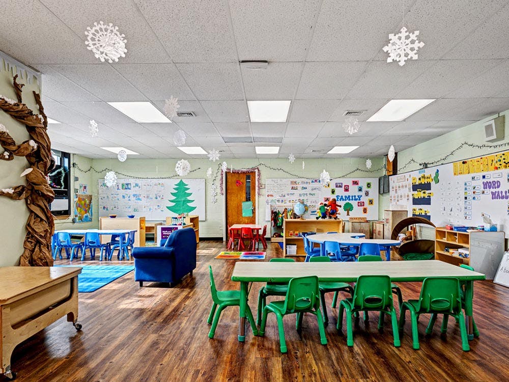 Classroom decorated with paper snowflakes and holiday lights
