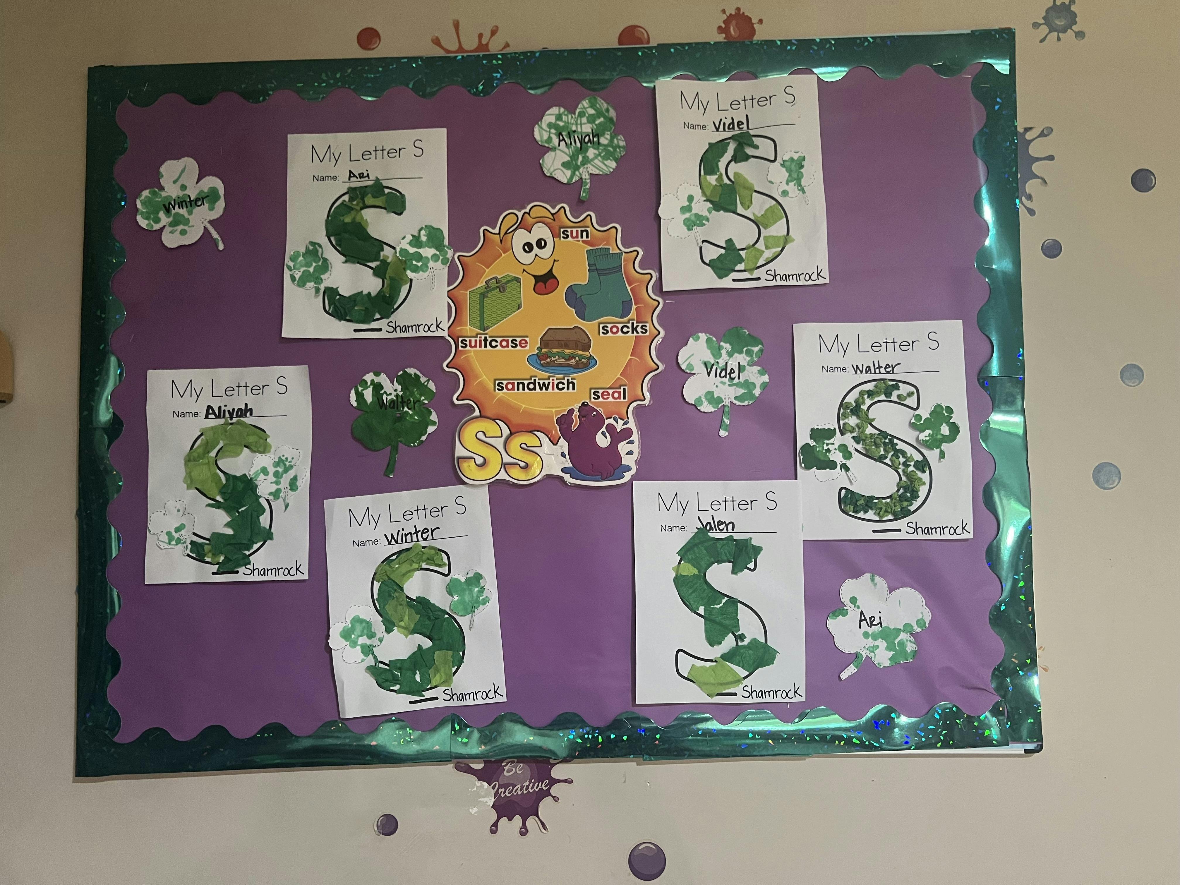 Classroom bulletin board displaying student projects for the letter S