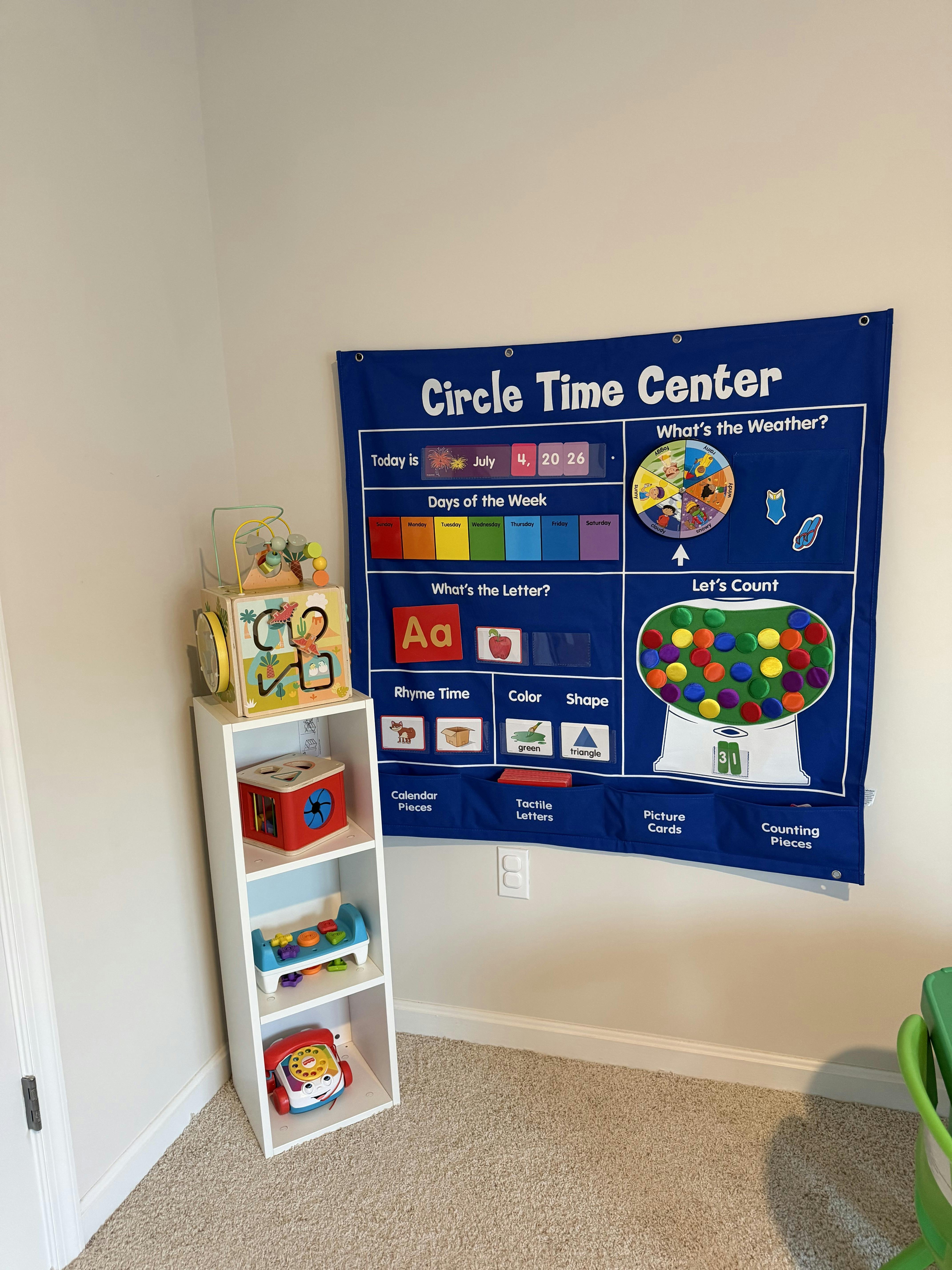 Educational wall hanging and children toys on a white shelf