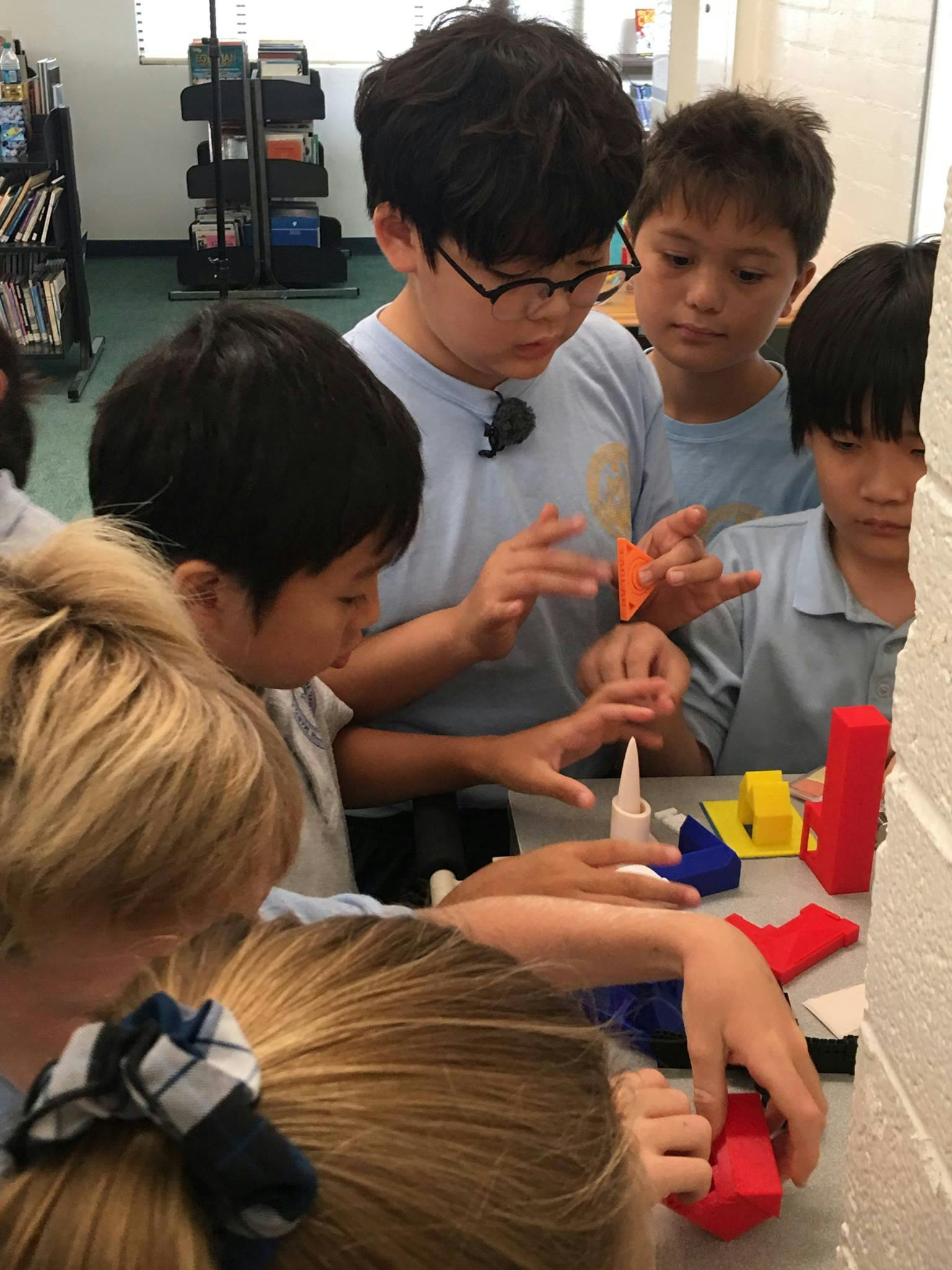 Children working with colorful blocks and glue