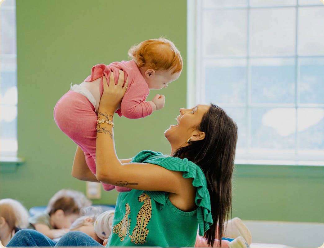 Person holding up an infant