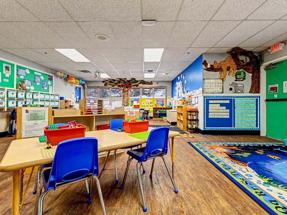 Classroom with tables, chairs, and play areas