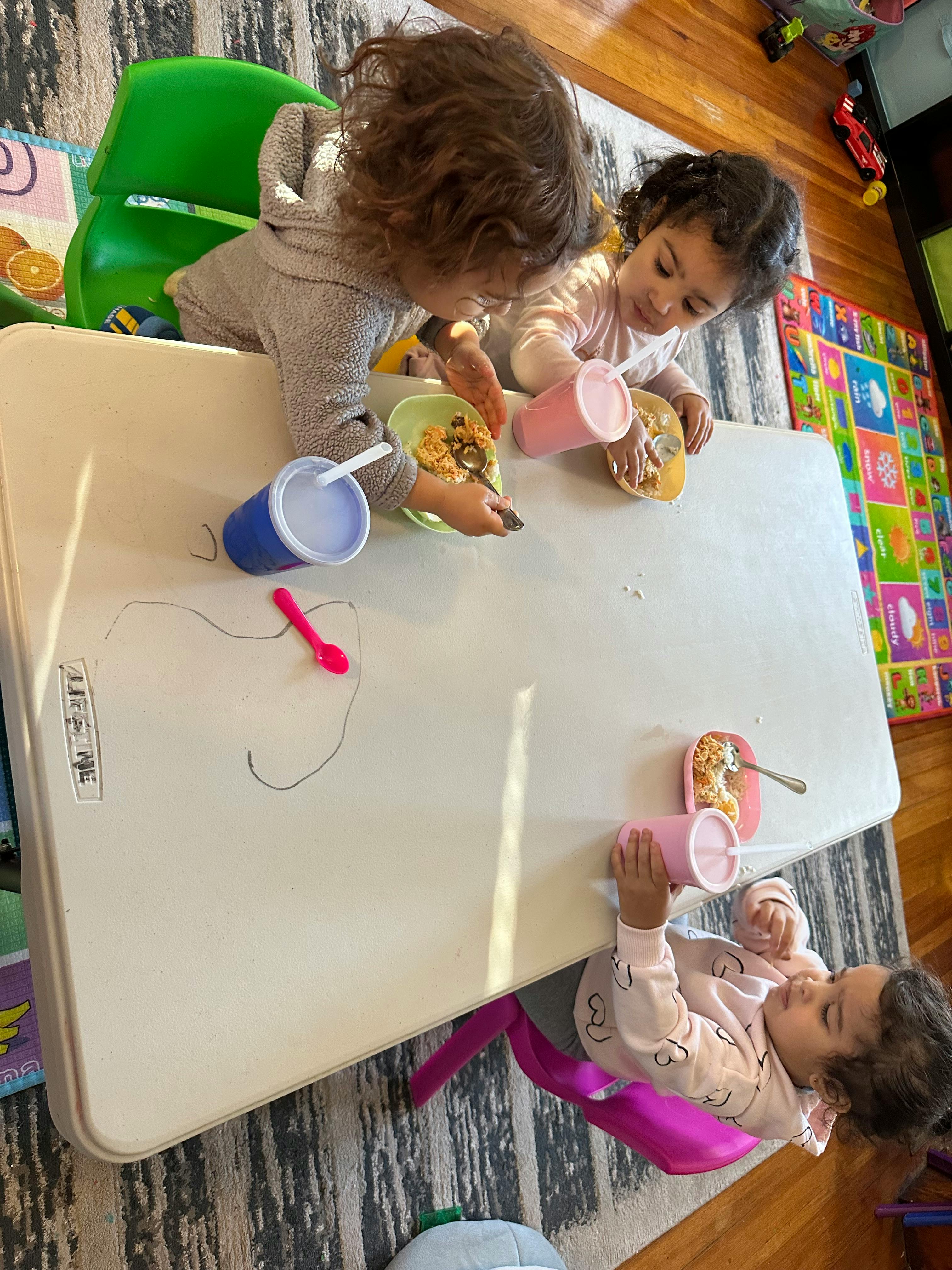 Three children eating at a table