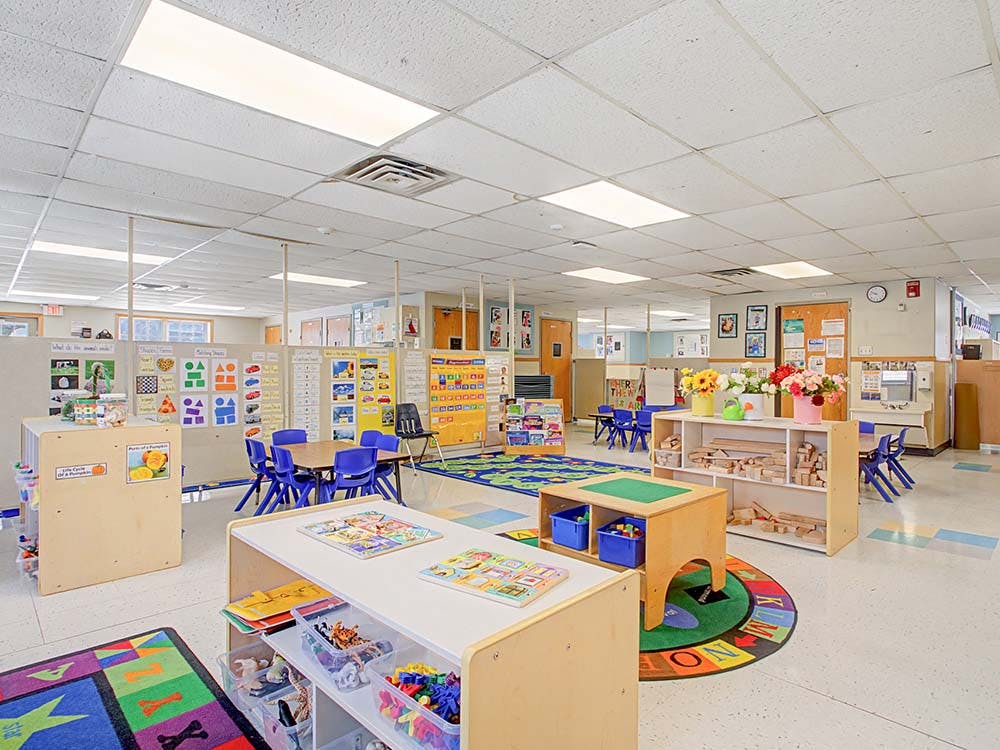 An empty early childhood classroom with multiple learning stations