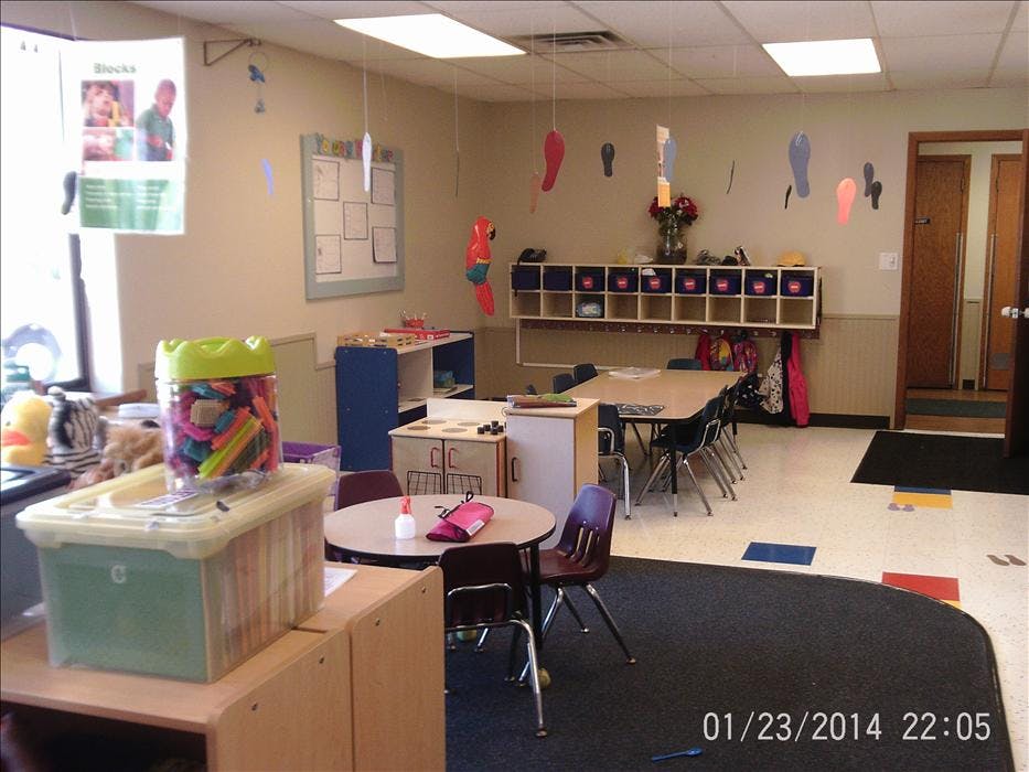 Classroom with tables, chairs, storage cubbies, and colorful decorations